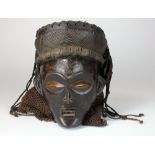 A Chokwe mask with braided hair and scarification marks to the face (some cracks to side of face),