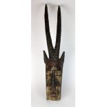 A large West African Dogon tribe antelope mask with painted surface,