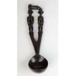 A large Philippines Ifuago carved wooden marriage spoon or ladle (bowl cracked, some chips to ears),