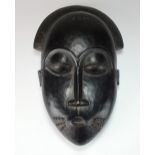 A West African Baule tribe mask with coffee bean eyes, 30.