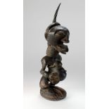 A large Songye tribe Nkisi power figure, Congo, with horn in top of head,