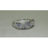 A 9ct white gold tanzanite and diamond dress ring designed as five triangular cut tanzanites