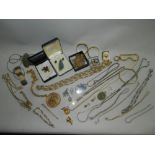 A collection of costume jewellery to include chain necklaces, earrings and a bracelet.