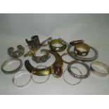 A collection of white metal and silver bangles together with brass bangles and a choker necklace.