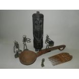 An African carved wooden ladle, a carved hardwood figure, a group of worked metal figures,