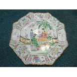 A Japanese porcelain charger of octagonal form and painted in the Chinese famile rose style with