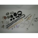 A collection of costume jewellery to include brooches, bangles and wristwatches.