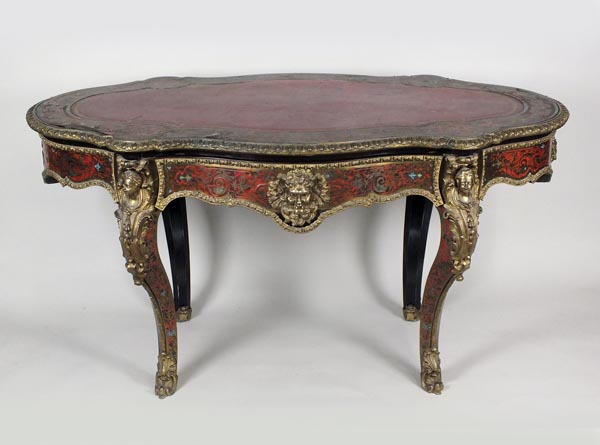 A 19th century Boulle style serpentine desk the well shaped top with central claret leather skiver