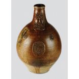 A large Rhineland brown, salt-glazed stoneware bellarmine or 'Bearded' face jug, 17th century,