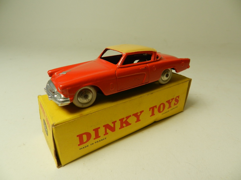 A boxed French Dinky Toys No 24Y Studebaker Commander, the model in orange/red with sand roof and