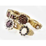 A 9ct gold opal and sapphire dress ring, together with a 9ct gold opal and garnet dress ring,