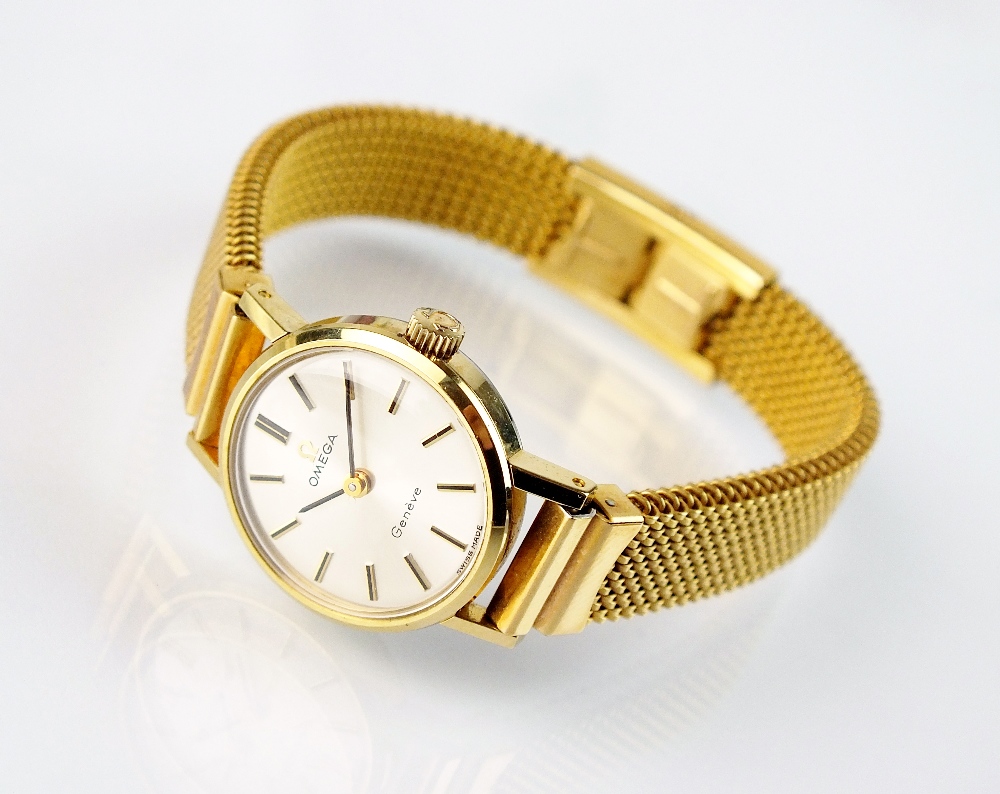 A lady's gold plated Omega wristwatch, the plain silvered dial with batons, manual wind,