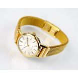 A lady's gold plated Omega wristwatch, the plain silvered dial with batons, manual wind,