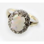 An opal and cubic zirconia oval cluster ring, the yellow metal shank stamped '9ct', ring size G 1/2,