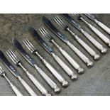 A set of twelve Edwardian Goldsmiths and Silversmiths mother of pearl and silver knives and forks,