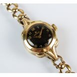 A lady's 9ct gold Rolex wristwatch, the circular black dial with gold Arabic numerals, manual wind,