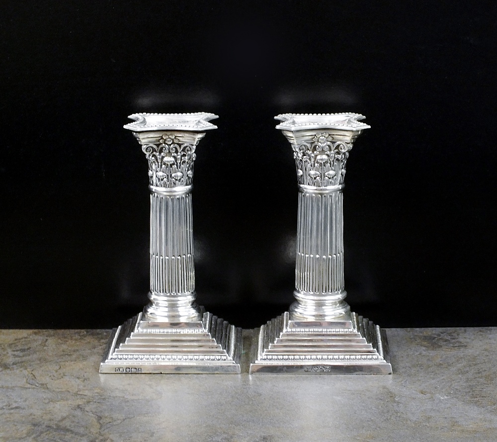 A pair of short silver Corinthian column candlesticks, Harrison Brothers & Howson,