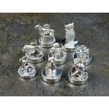 A harlequin set of eight silver mounted novelty place holders, S.J.