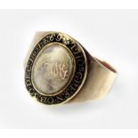 A Georgian mourning ring, designed as a central oval glazed aperture with enclosed lock of hair,