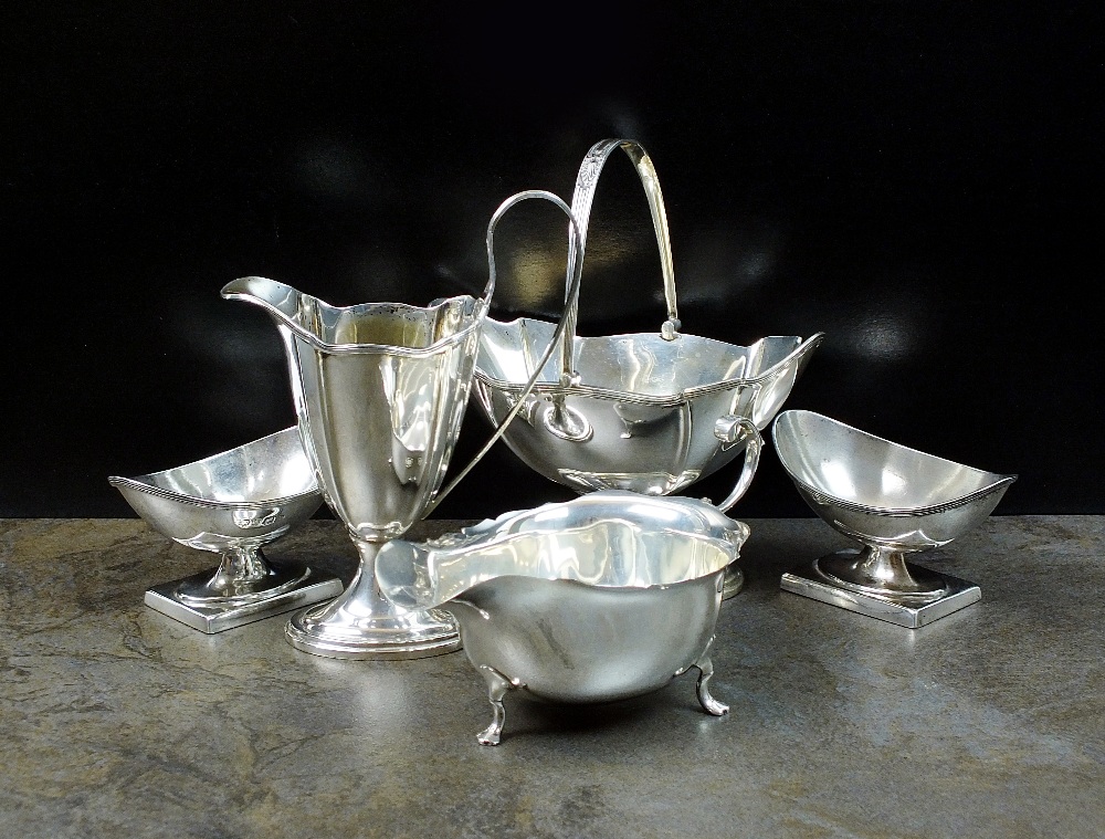 A silver swing handled sugar bowl and helmet cream jug, GW & S, Birmingham 1907,