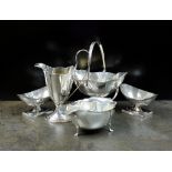 A silver swing handled sugar bowl and helmet cream jug, GW & S, Birmingham 1907,