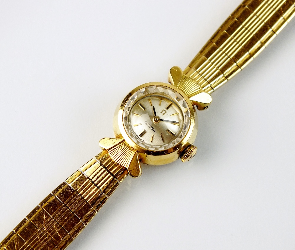 A Lady's 18ct gold Omega bracelet wristwatch, the circular silvered dial with batons, manual wind,