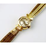 A Lady's 18ct gold Omega bracelet wristwatch, the circular silvered dial with batons, manual wind,