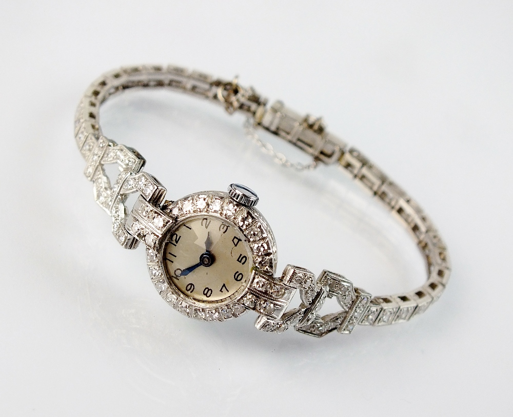 A lady's white metal diamond set bracelet watch,