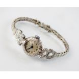 A lady's white metal diamond set bracelet watch,