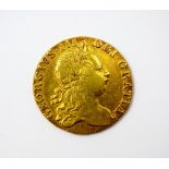 A George III guinea, dated 1768, third Laureate head, crowned shield of arms,