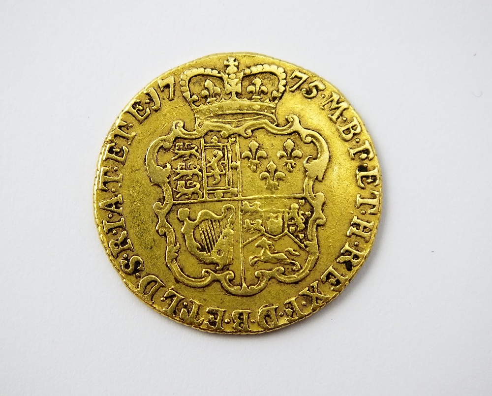 A George III guinea, dated 1775, fourth Laureate head, reverse; crowned shield of arms, - Image 2 of 2