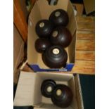 A set of turned wood lawn bowling balls, some with monogrammed tablets,