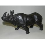 A bronze clad model of a rhinoceros.