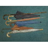 A bundle of five assorted umbrellas,