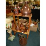 A collection of 19th/20th century copper wares to include graduated skillets, hay stack measures,