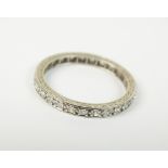 A diamond set full hoop eternity ring, the brilliant cut diamonds claw set in white metal,