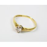An 18ct gold single stone diamond ring, the brilliant cut diamond claw set to yellow gold shank,