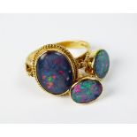 An opal triplet dress ring, the yellow metal shank stamped '750',