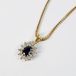 An 18ct gold sapphire and diamond cluster pendant,