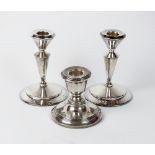A pair of silver mounted candlesticks, James Deakin & Sons, Birmingham 1911, 12cm high,