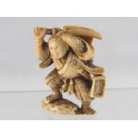 A stained ivory netsuke of a warrior, ht