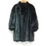 A three quarter length black mink coat,