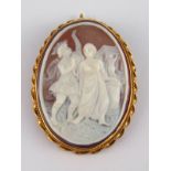 A carved shell cameo brooch in a yellow