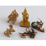 Three 9 carat gold charms (18gms), togeh