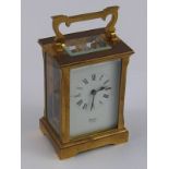 A brass carriage clock and key,  dial si