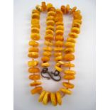 An amber necklace, approx 64cm long, bea