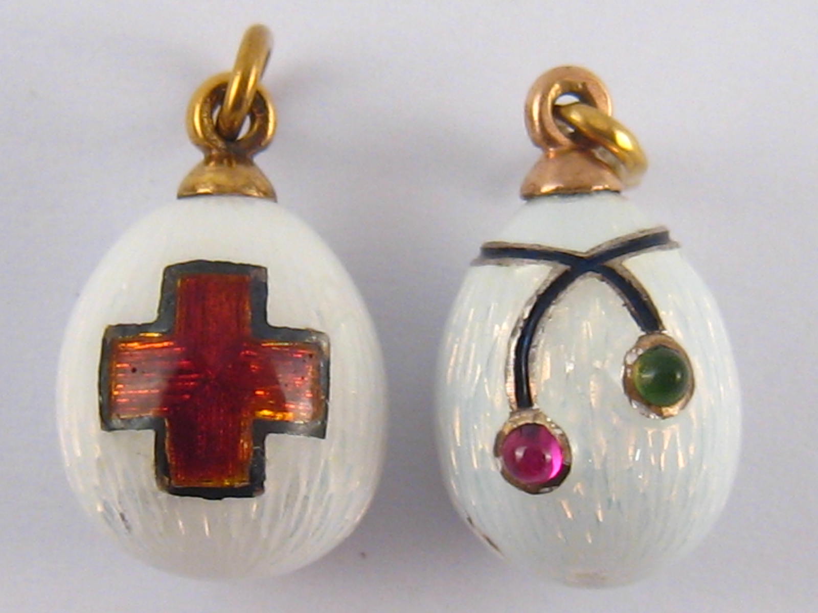Two Russian guilloche enamelled eggs, one with Red Cross emblem, marked 56, approx 14 ct.