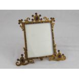 A gilt metal frame set with red stones, approx  19cm high.
