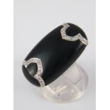 A white metal (tests 18 carat gold) diamond and onyx ring, approx 3cm long, size N, 9.