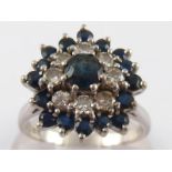 An 18 carat white gold sapphire and diamond cluster ring, size O, 5.9 gms.